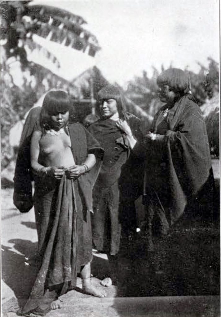 A group of three Sipibo in cloaks