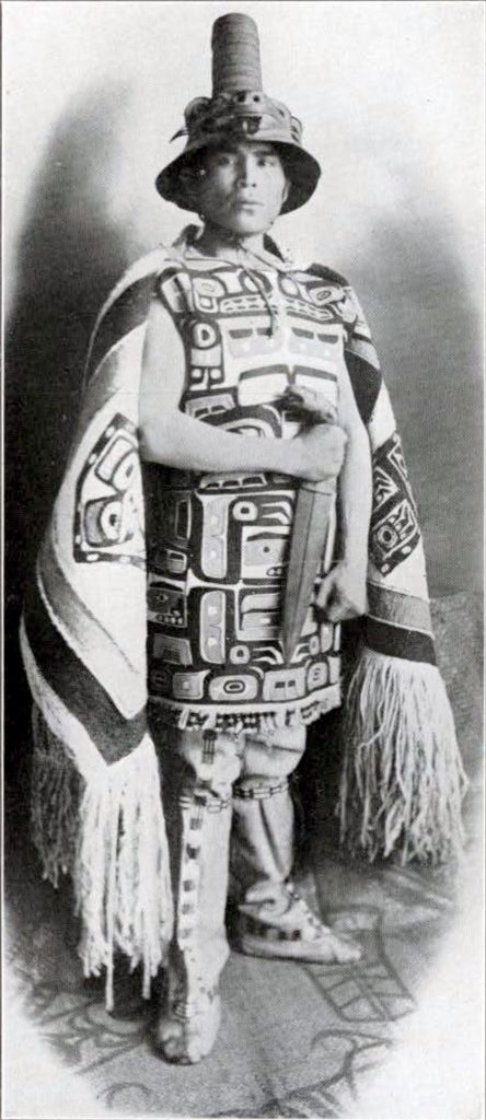 Louis Shotridge in his native costume holding a knife