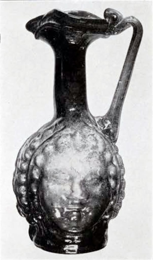 Small pitcher with body molded to look like a head and face