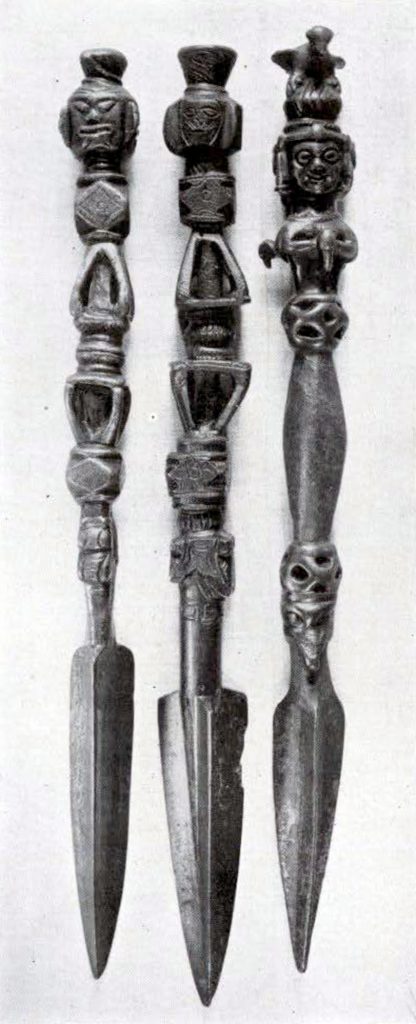 Three wrought iron phurpas with handles decorated with heads and shapes