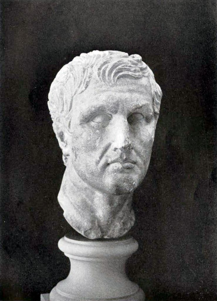 Marble bust of Menander, clean shaven with deep sunk eyes and hair parted on the left