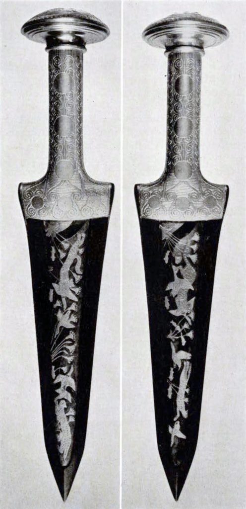 An inlaid dagger with a gold hilt with a running lion decoration