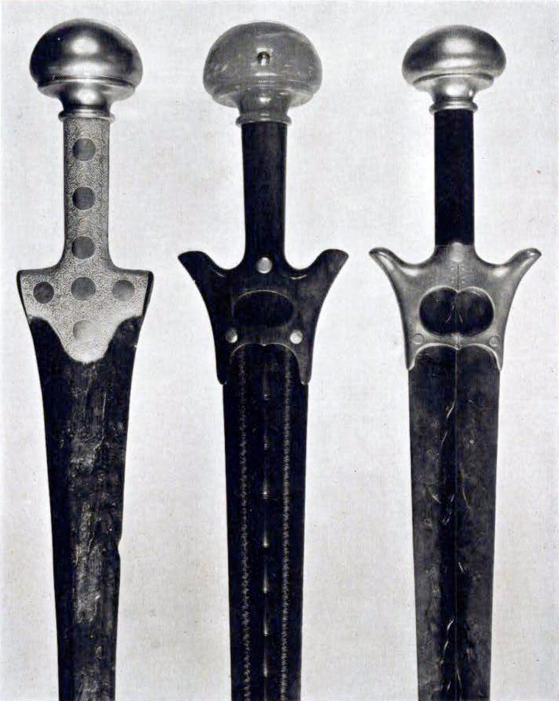 Three sword hilts, two that are winged
