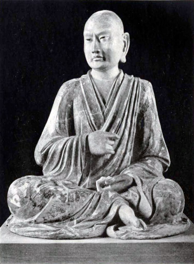 Figure of a luohan seated cross legged in meditation wearing a jiasha