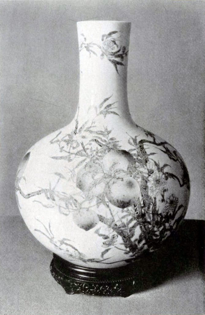 Vase with bulbous bottom featuring peach tree branches