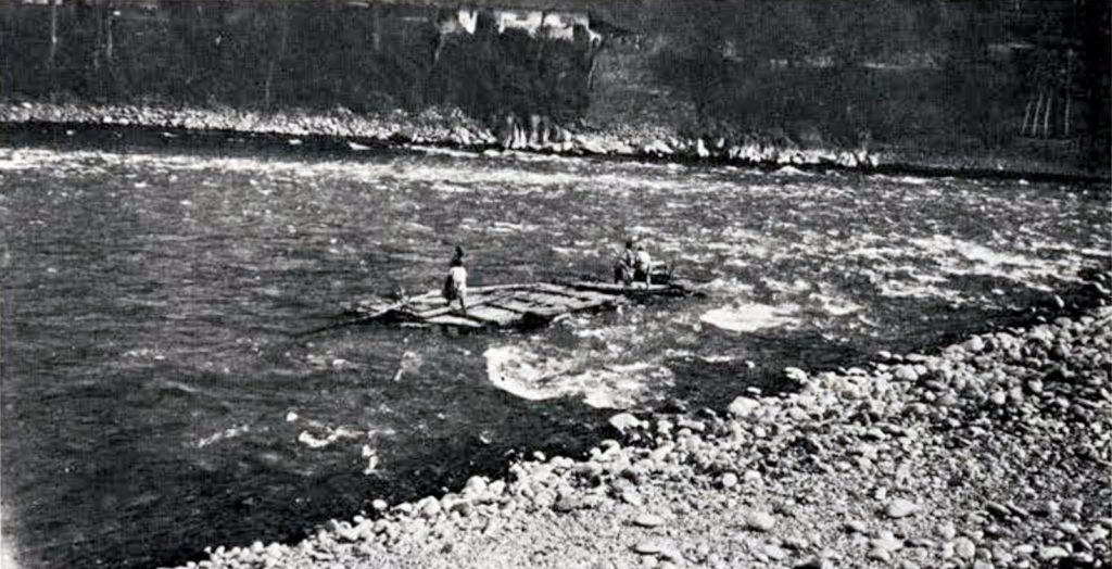 Two men on a raft in the river