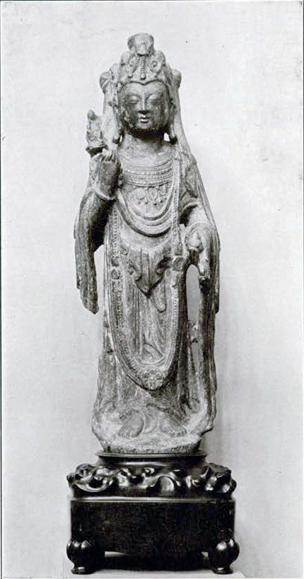 Stone bodhisattva holding a flower with a small deity, luxurious clothing