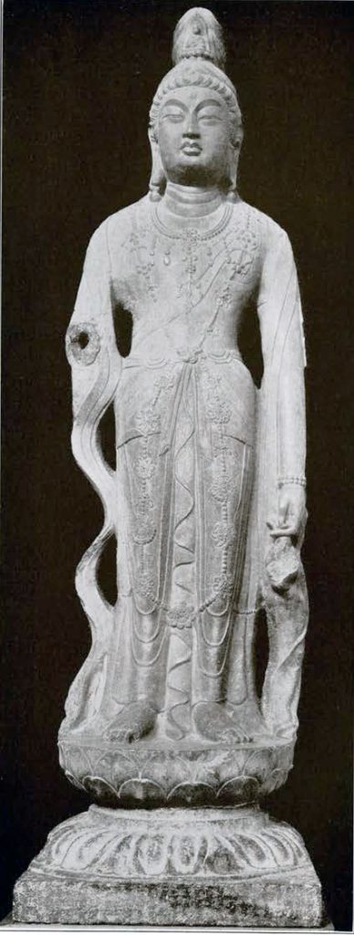 Stone statue of Guanyin on a lotus pedestal with long flowing sleeves and a seated Buddha in his headdress