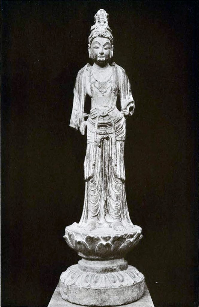 Grey limestone Bodhisattva with a headdress depicting the begging bowl of the Buddha, lower arms are missing