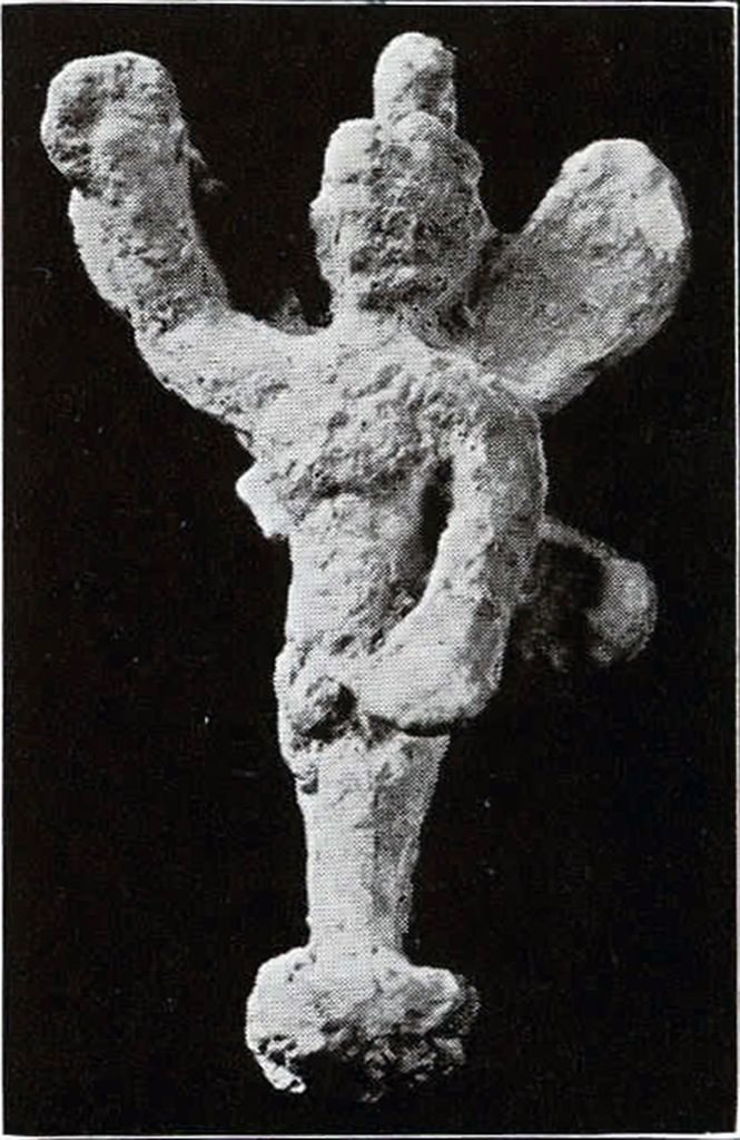 A crude humanoid figure with four wings and an arm raised