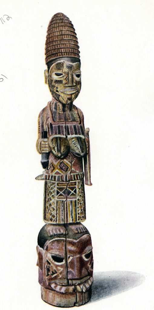 A carved wooden mask of a woman with a child on her back, standing atop a head, painted