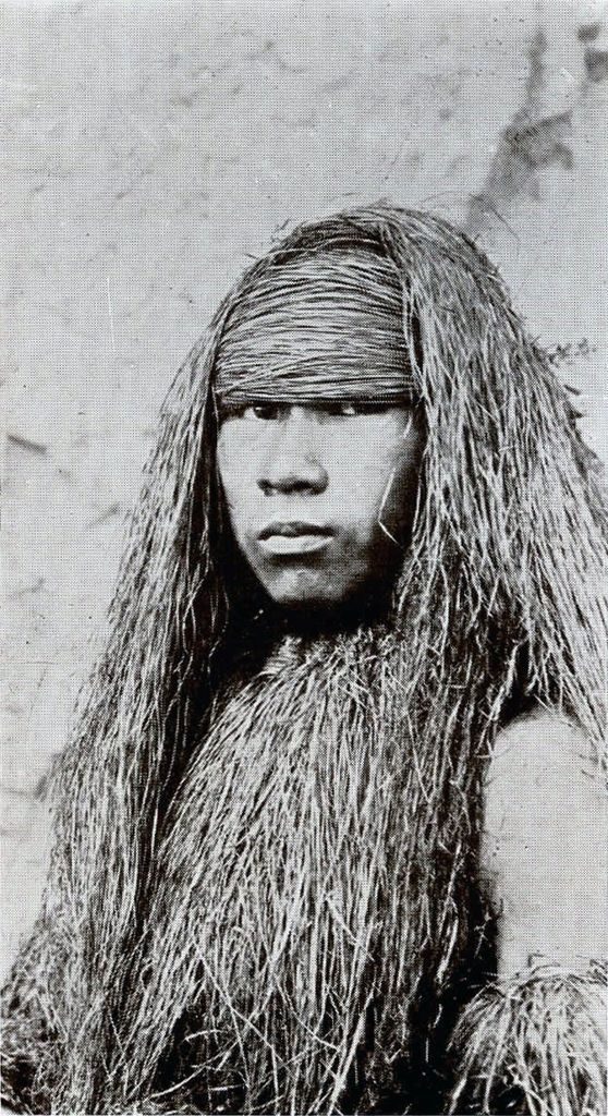 Close up portrait of a man in clothing made of grass, specifically the headpiece