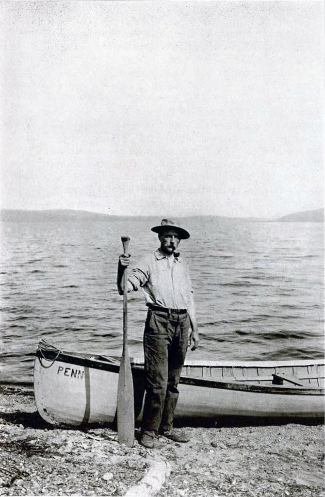 GBG standing with his canoe on the shore of Lake Minchumina