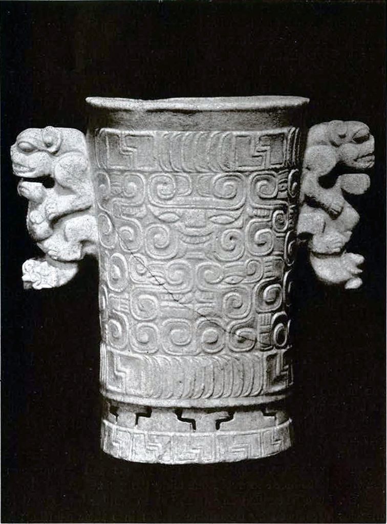 A marble vase with swirling pattern and two animal handles