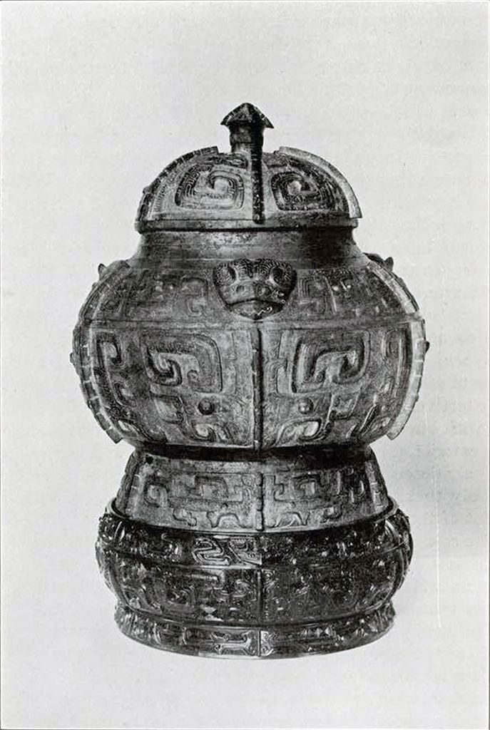 Bronze wine jar divided into three equal vertical sections which are each divided down the center, decorated with animal heads