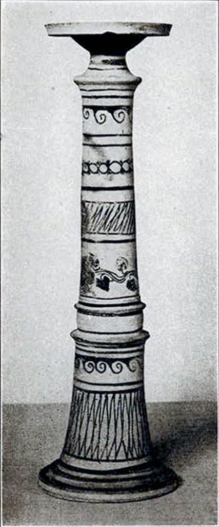 A tall tubular incense burner