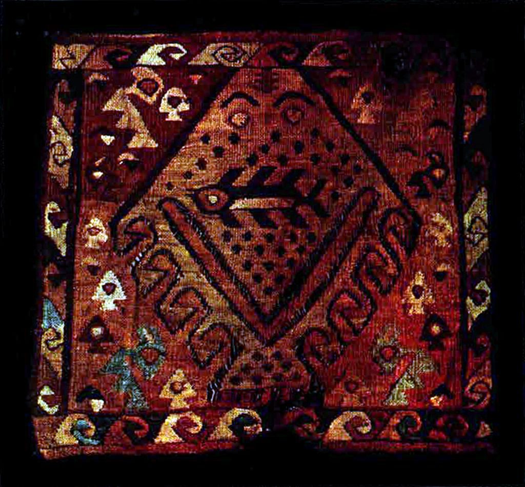 Square of a tapestry with a shark in the middle and fish around