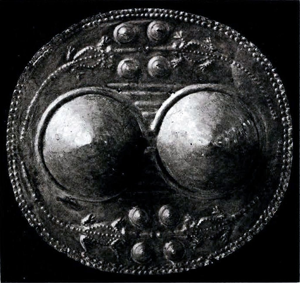 A circular breastplate with bosses and crocodiles