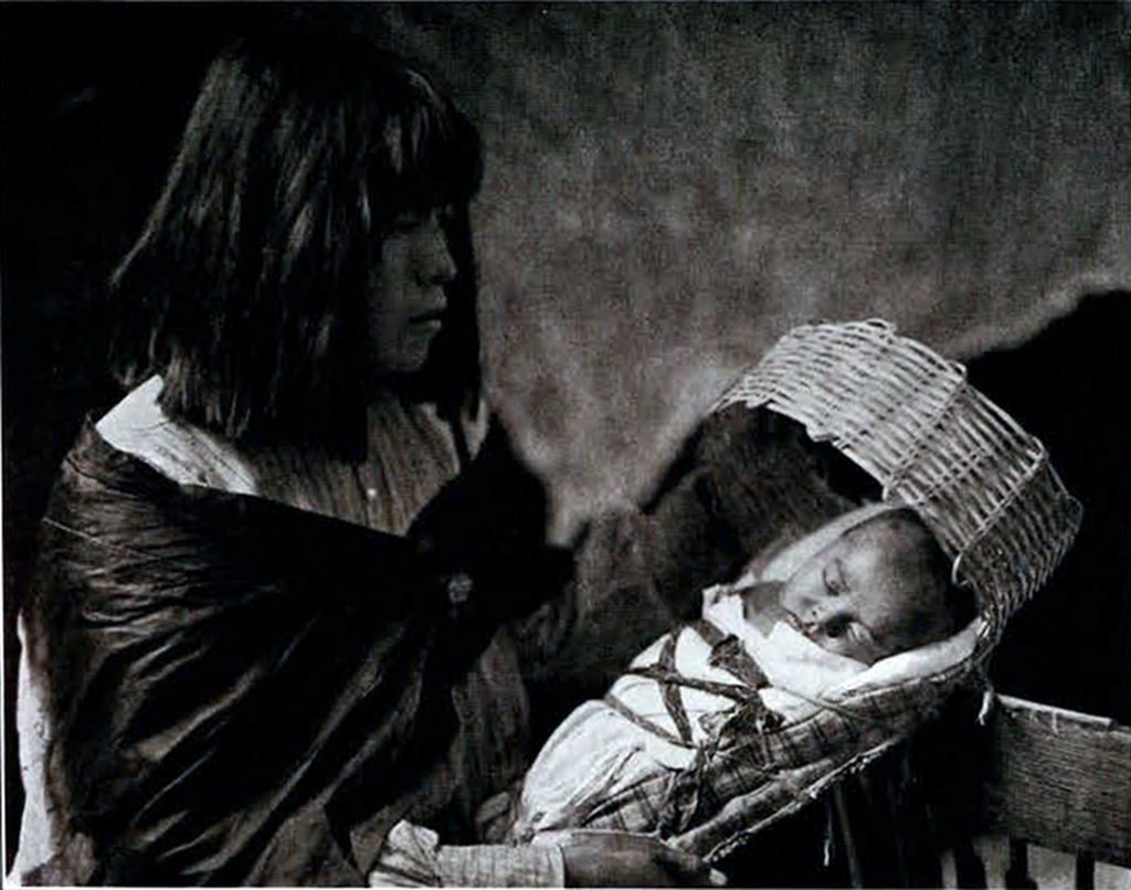 A Havasupai woman with her sleeping child