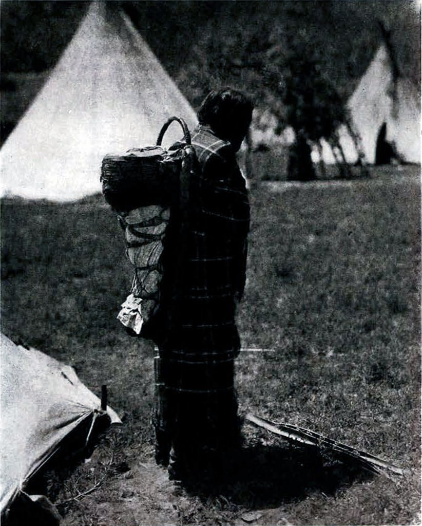 An Apache woman carrying her child on her back in a cradle