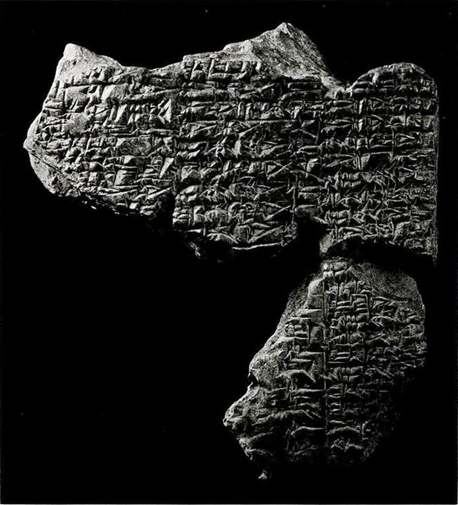 Two clay tablet fragments joined together to show continuous Cuneiform