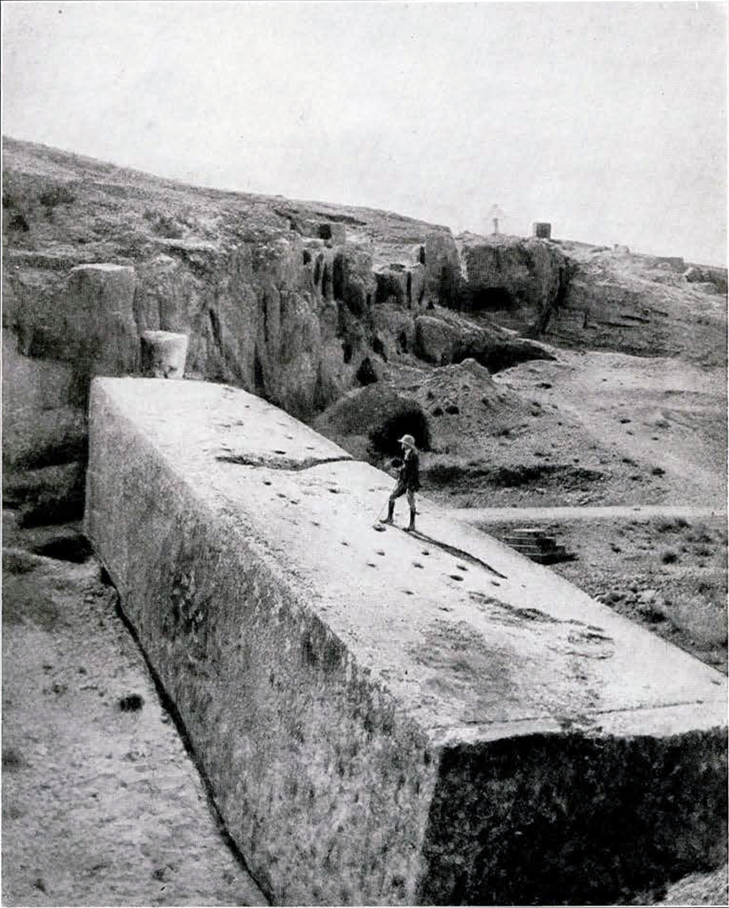 Man walking atop a large quarry stone