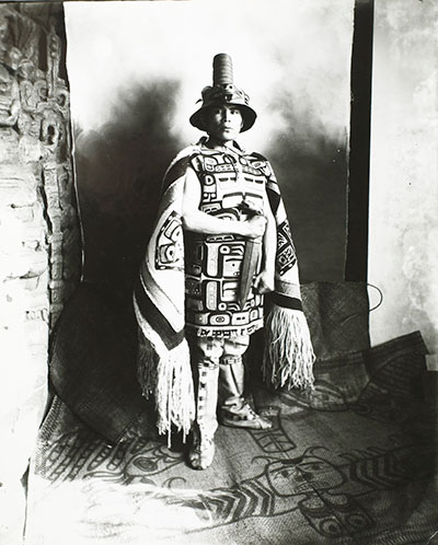Black and white photo of Louis Shotridge in clan regalia holding a dagger