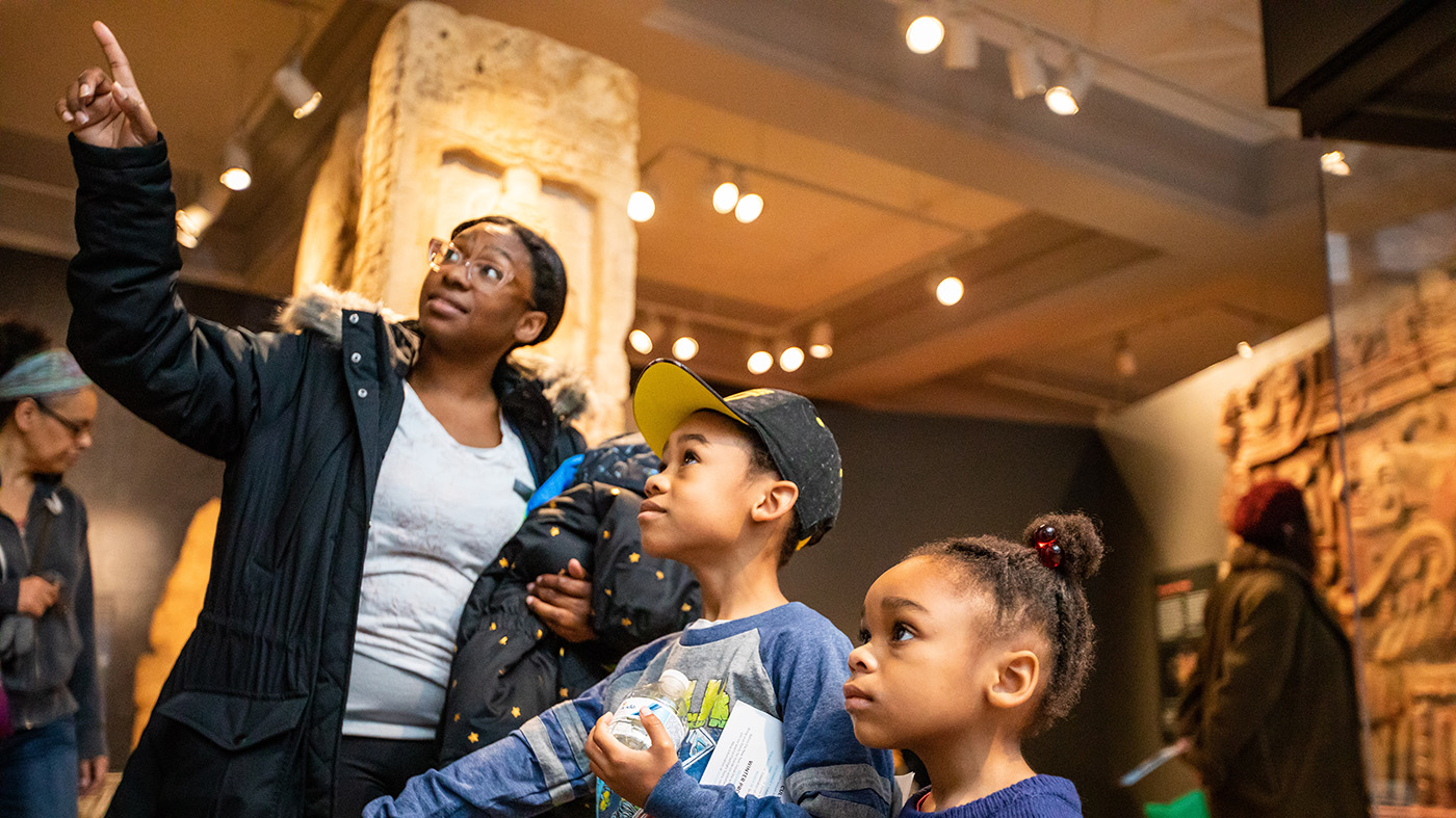 A family walks through the interactive Mexico and Central America Gallery at the Penn Museum during Winter Break.