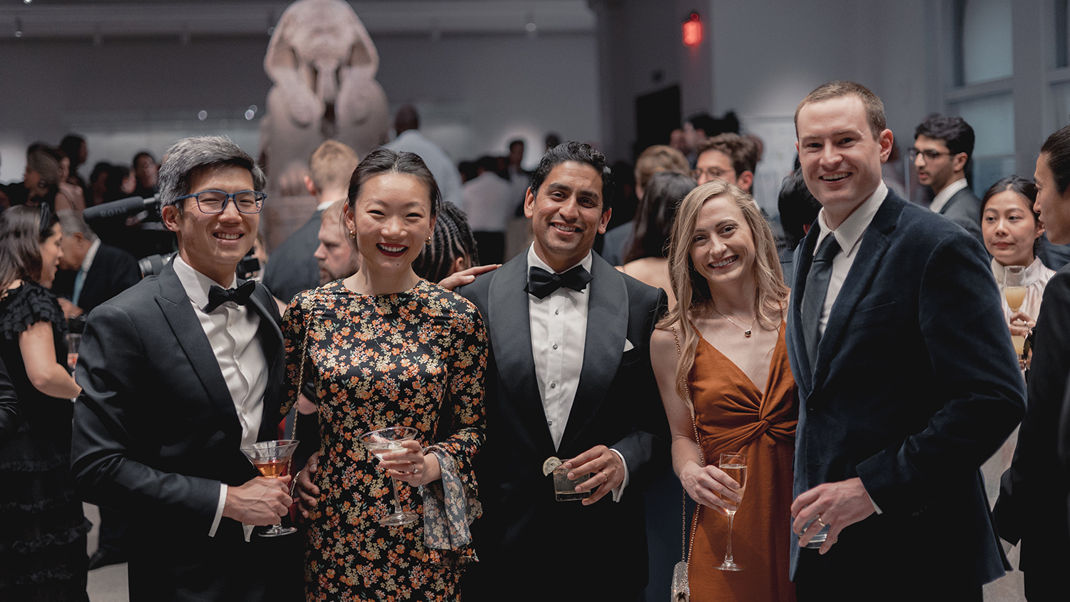 Group shot of wedding guests at a Penn Museum space.