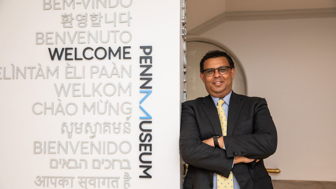 Director Christopher Woods in front of the welcome plaques at the Museum.