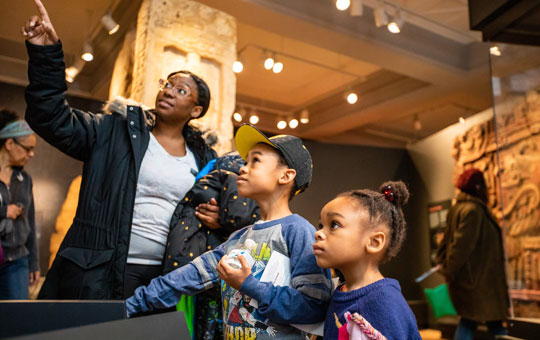 A family looking at a museum exhibit.