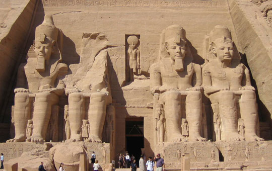 Entrance to a monument in Lower Nubia, with massive statues of seated pharaohs.