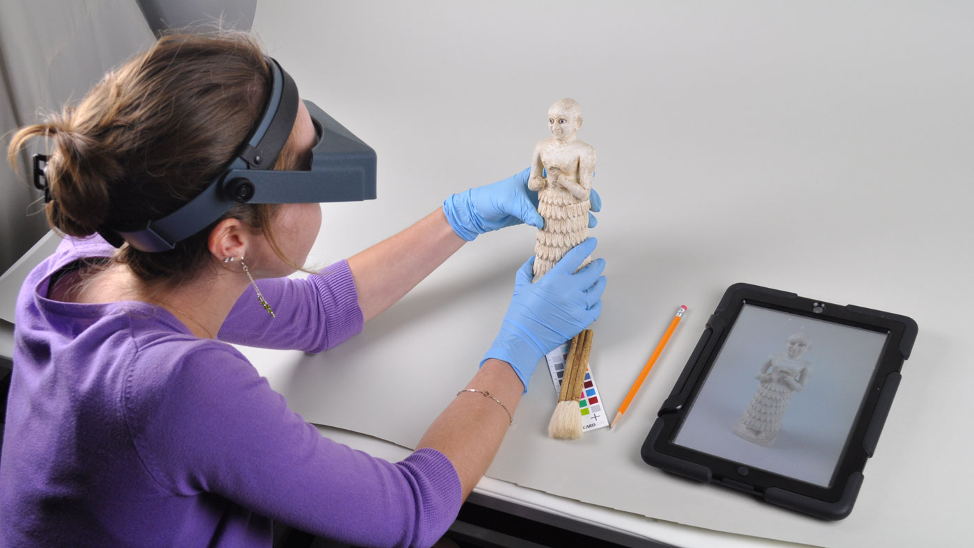 A registrar making a condition report of an artifact.