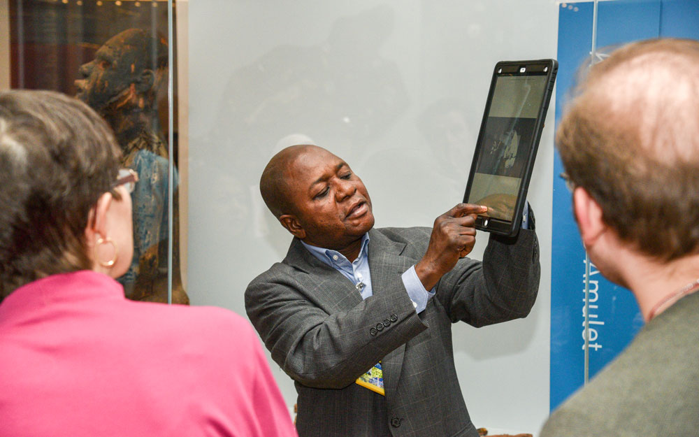 A global guide giving a tour in the Africa Galleries.