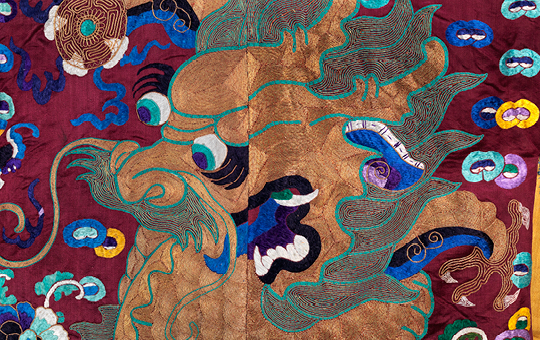 A depiction of a dragon found on a satin robe.