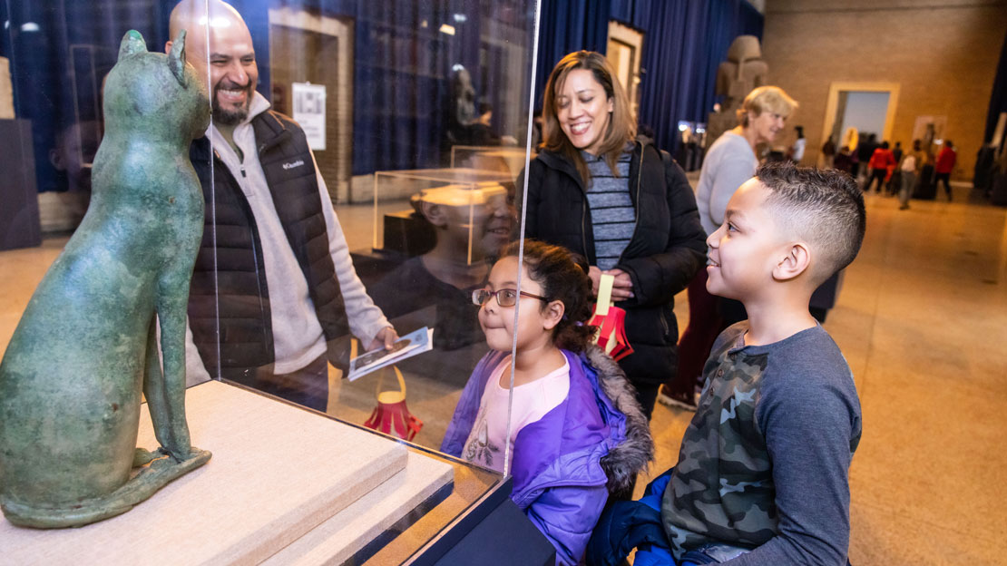 A family looking at an artifact in the Egypt gallery.