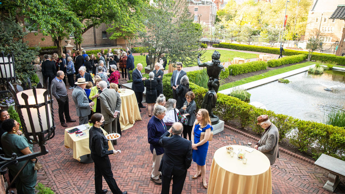 Donors mingling at a catered event in the Warden Garden.