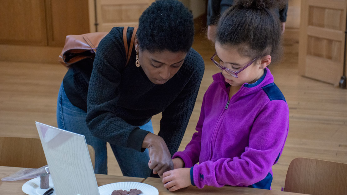 A mother and daughter working on a museum craft together.