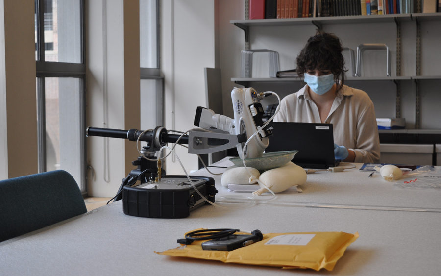 A student using a microscope to research the collection.