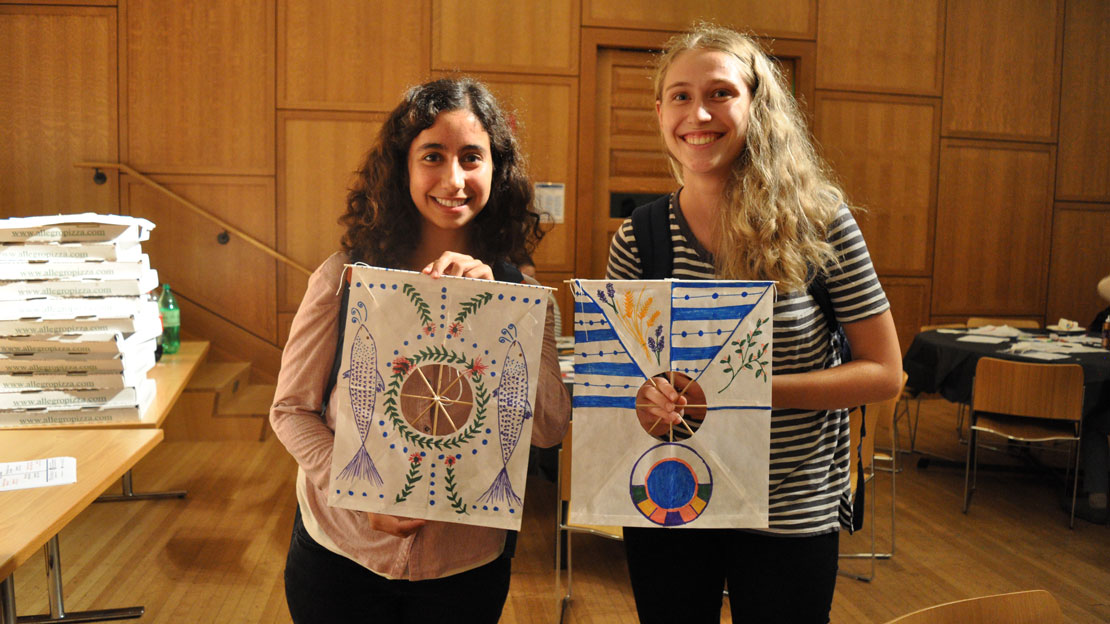 two students showing off kites they made