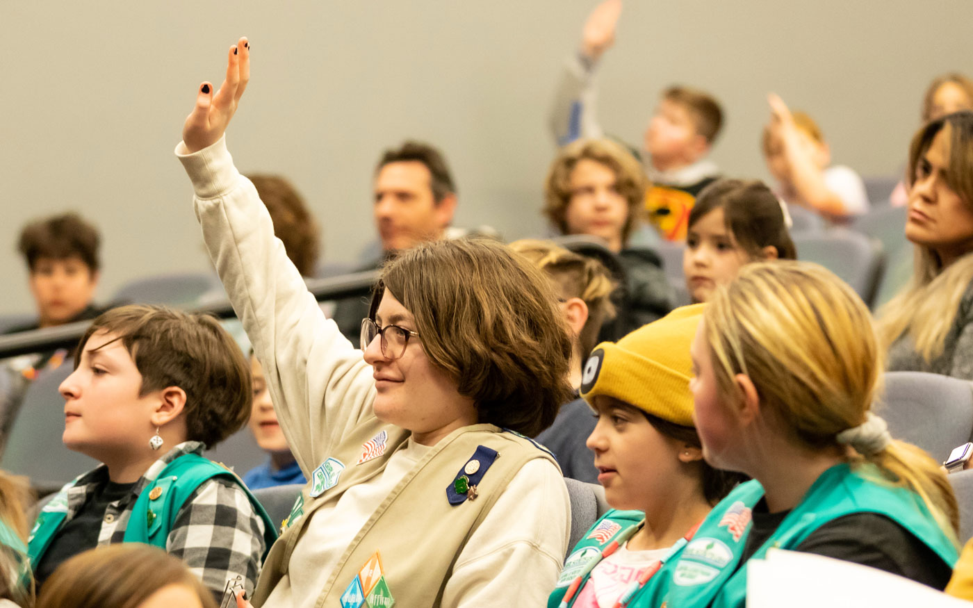 A group of scouts seated together during a program.