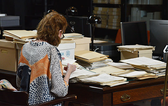 A person sitting a desk, working.