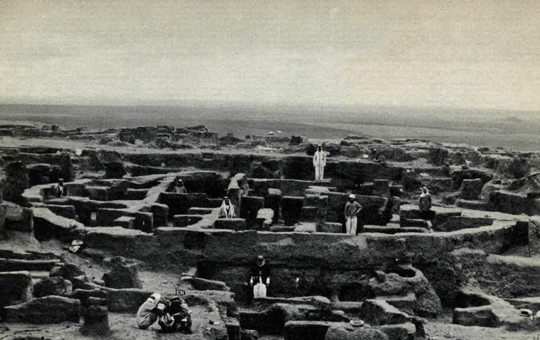 View of the excavated round House, people standing about.