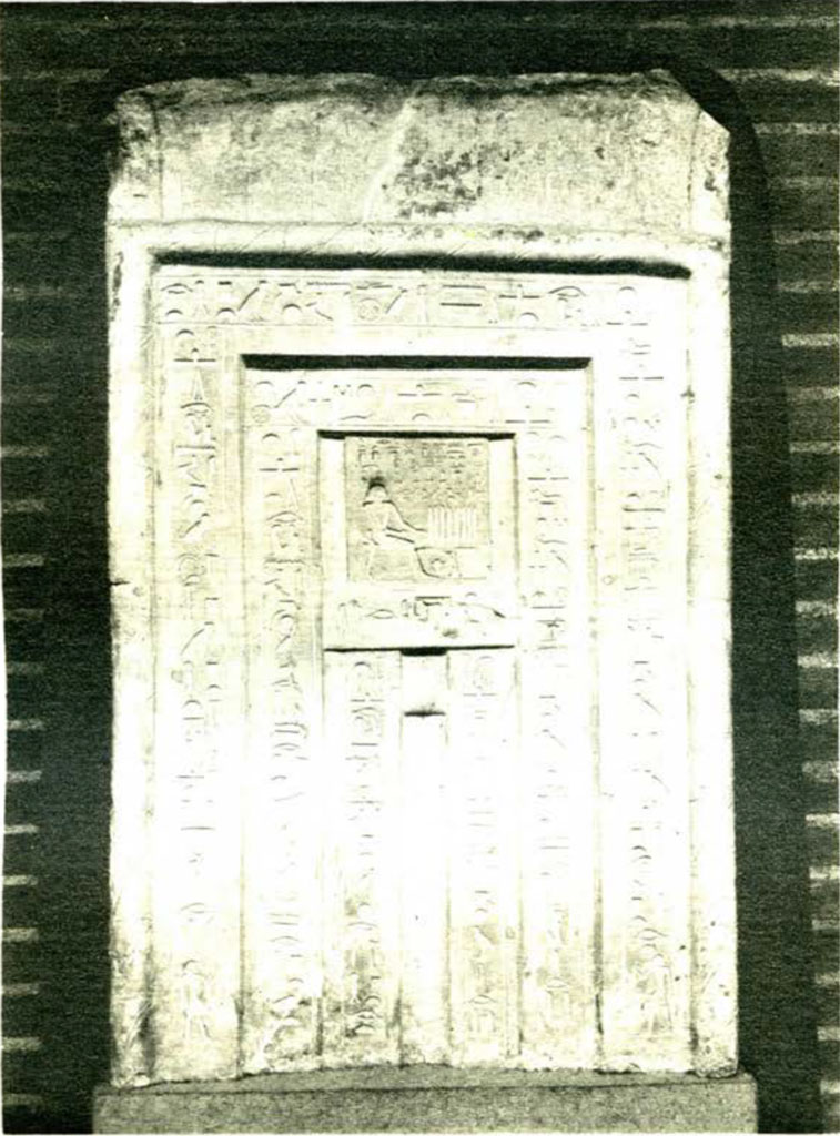 Large stone false door depicting funerary scenes and inscriptions in concentric rectangles