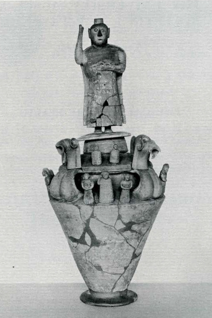 Conical urn decorated with several small human figures and griffins, and a large human figure with one arm raised on the lid