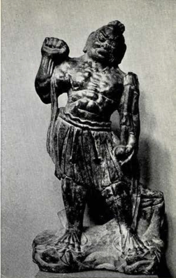 Stone statuette of Buddhist guardian, nude to the waist and the thick neck and broad muscular chest, right arm raised as if to strike; left arm hanging at side holds gourd