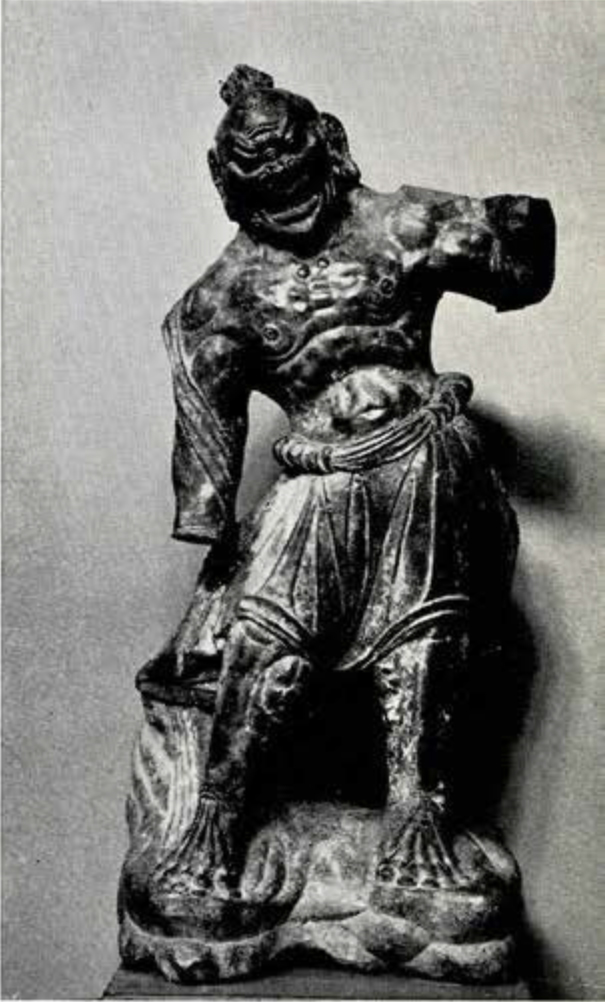Stone statuette of Buddhist guardian, nude to the waist and the thick neck and broad muscular chest, both arms are broken at elbow