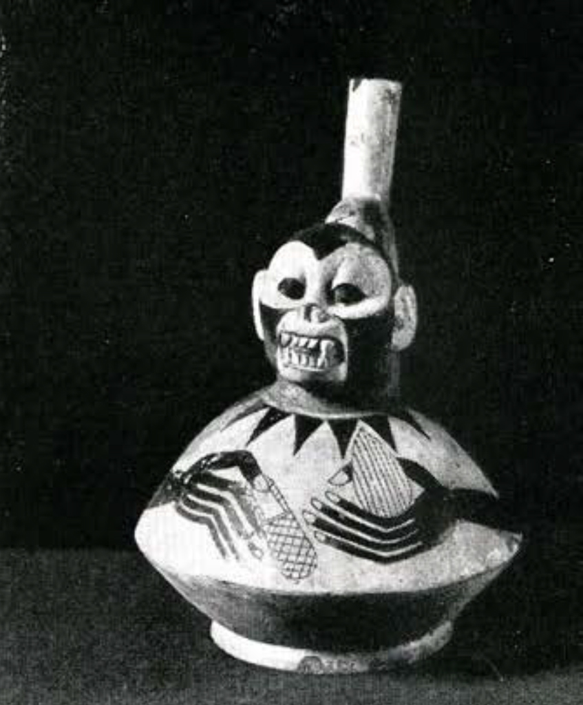 Stirrup spouted effigy vessel with a round body and a monkey head, hands painted on the body