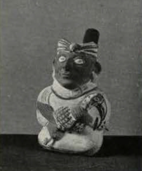 Stirrup spout effigy vessel of a seated man holding a long-billed bird