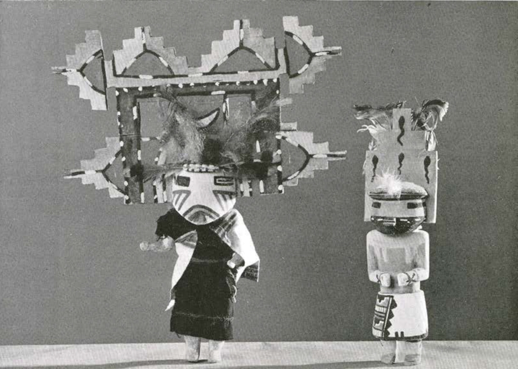Two Katchina dolls, one with a stepped, tableta headdress with feathers, the other with a small tableta headress depicting tadpoles